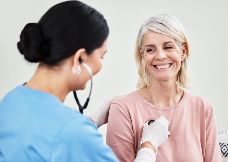 Shot of a female doctor examining a patient with a stethoscope 